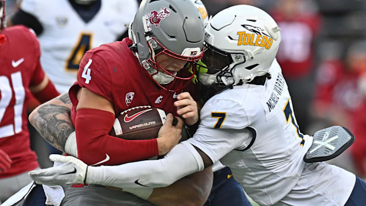 Washington State Cougars quarterback Zevi Eckhaus (4) is tackled by Toledo Rockets safety Emmanuel McNeil-Warren (7) in the second half at Gesa Field at Martin Stadium.