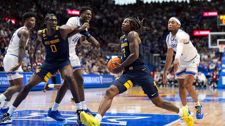 Dec 31, 2024; Lawrence, Kansas, USA; West Virginia Mountaineers guard Javon Small (7) drives against the Kansas Jayhawks during the first half at Allen Fieldhouse. Mandatory Credit: Jay Biggerstaff-Imagn Images