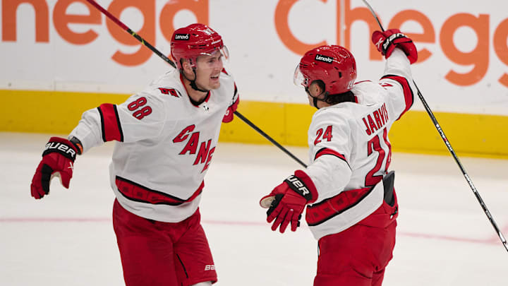 Oct 17, 2023; San Jose, California, USA; Carolina Hurricanes center Seth Jarvis (24) celebrates with center Martin Necas (88) after scoring a goal against the San Jose Sharks during the third period at SAP Center at San Jose. Mandatory Credit: Robert Edwards-Imagn Images