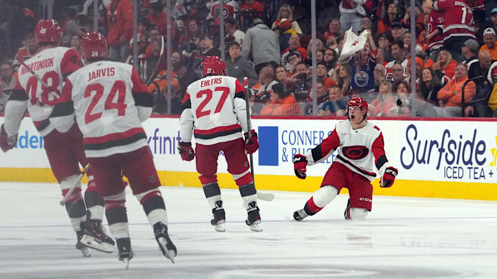 May 9, 2026; Philadelphia, Pennsylvania, USA; Carolina Hurricanes right wing Jackson Blake (right) celebrates his game-winning goal in overtime against the Philadelphia Flyers in game four of the second round of the 2026 Stanely Cup Playoffs at Xfinity Mobile Arena. Mandatory Credit: James Lang-Imagn Images