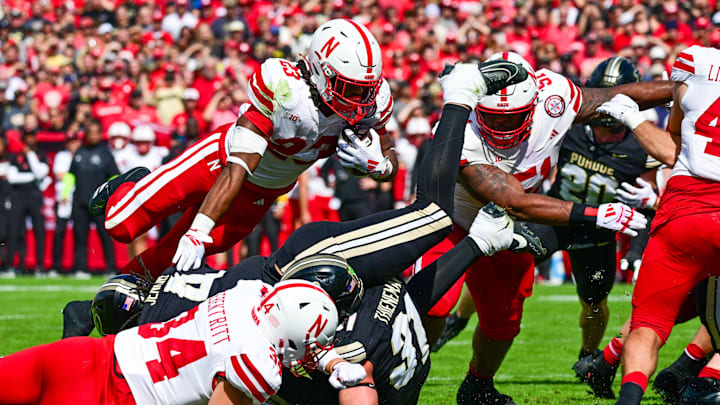 Sep 28, 2024; West Lafayette, Indiana, USA; Nebraska Cornhuskers running back Dante Dowdell (23) jumps over Purdue Boilermakers linebacker Kydran Jenkins (4) for a touchdown during the second half at Ross-Ade Stadium. Images