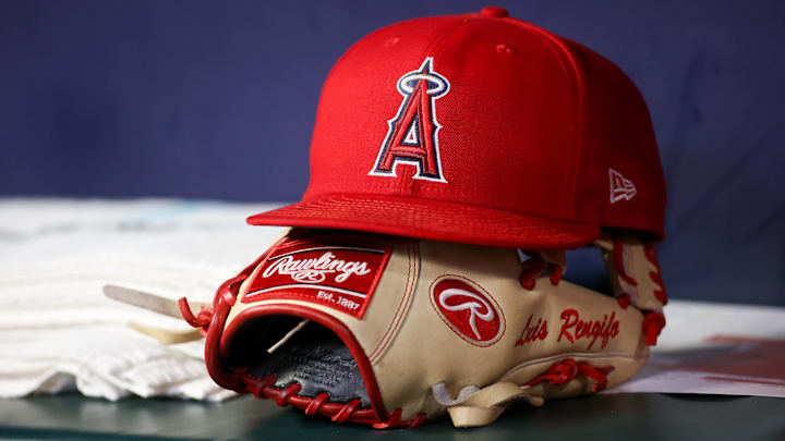 Aug 1, 2023; Atlanta, Georgia, USA; A detailed view of a Los Angeles Angels hat and glove on the bench against the Atlanta Braves in the eighth inning at Truist Park. Mandatory Credit: Brett Davis-Imagn Images