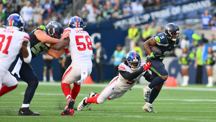 Oct 6, 2024; Seattle, Washington, USA; New York Giants linebacker Kayvon Thibodeaux (5) tackles Seattle Seahawks running back Kenneth Walker III (9) during the second half at Lumen Field.  
