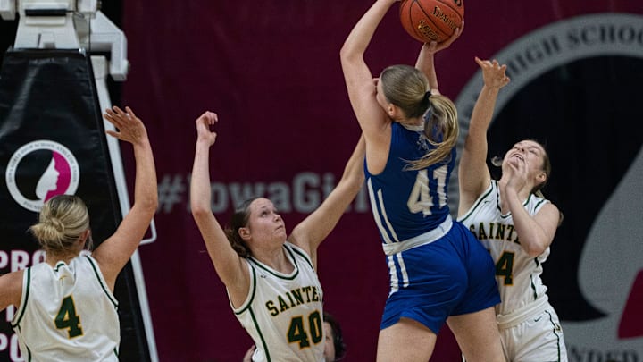 Newell-Fonda's Kinzee Hinders attempts a shot against Council Bluffs St. Albert's Avah Underwood (40) and Lexie Pearce (14) during the 1A IGHSAU state basketball championship at Wells Fargo Arena on Saturday.