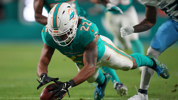 Miami Dolphins safety Elijah Campbell (22) recovers a muffed punt against the Tennessee Titans during the second half of an NFL game at Hard Rock Stadium in Miami Gardens, Dec. 11, 2023.