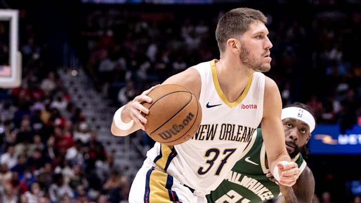Mar 28, 2024; New Orleans, Louisiana, USA;   New Orleans Pelicans forward Matt Ryan (37) dribbles against Milwaukee Bucks guard Patrick Beverley (21) during the second half at Smoothie King Center. Mandatory Credit: Stephen Lew-Imagn Images
