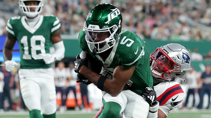 Sep 19, 2024; East Rutherford, New Jersey, USA; New York Jets wide receiver Garrett Wilson (5) is tackled by New England Patriots cornerback Marcus Jones (25) during the third quarter at MetLife Stadium. Mandatory Credit: Brad Penner-Imagn Images Sep 19, 2024; East Rutherford, New Jersey, USA; New York Jets wide receiver Garrett Wilson (5) is tackled by New England Patriots cornerback Marcus Jones (25) during the third quarter at MetLife Stadium. Mandatory Credit: Brad Penner-Imagn Images