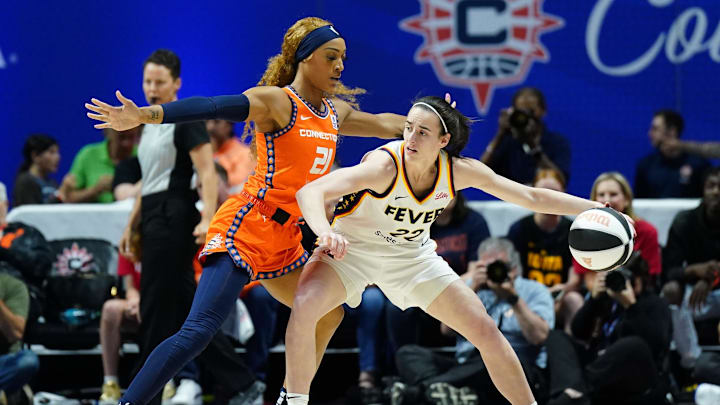 Jun 10, 2024; Uncasville, Connecticut, USA; Indiana Fever guard Caitlin Clark (22) moves the ball against Connecticut Sun guard DiJonai Carrington (21) in the first quarter at Mohegan Sun Arena. Mandatory Credit: David Butler II-Imagn Images