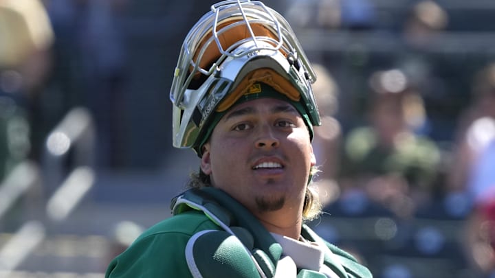 Oakland Athletics catcher Yohel Pozo fields the ball against the Cleveland Guardians in the first inning at Hohokam Stadium in Mesa, Ariz., on March 4, 2023. 