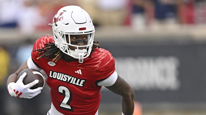 Sep 21, 2024; Louisville, Kentucky, USA;  Louisville Cardinals wide receiver Jadon Thompson (2) tries to break free from the tackle of Georgia Tech Yellow Jackets defensive back Ahmari Harvey (3) during the second half at L&N Federal Credit Union Stadium. Mandatory Credit: Jamie Rhodes-Imagn Images