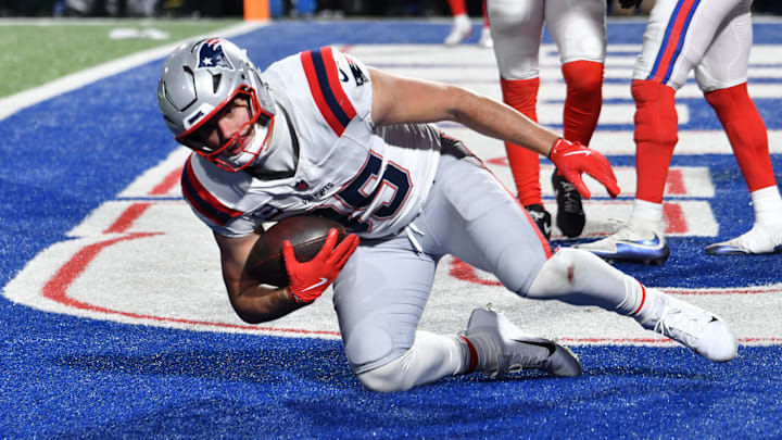 Dec 22, 2024; Orchard Park, New York, USA; New England Patriots tight end Hunter Henry (85) scores a touchdown  against the Buffalo Bills in the fourth quarter at Highmark Stadium. Mandatory Credit: Mark Konezny-Imagn Images