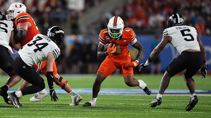 Dec 28, 2024; Orlando, FL, USA; Miami Hurricanes running back Mark Fletcher Jr. (4) runs the ball against the Iowa State Cyclones during the second half at Camping World Stadium. Mandatory Credit: Jasen Vinlove-Imagn Images