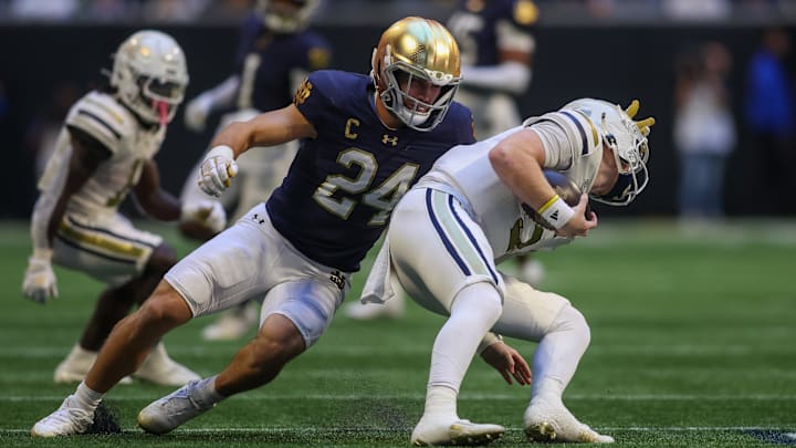 Oct 19, 2024; Atlanta, Georgia, USA; Notre Dame Fighting Irish linebacker Jack Kiser (24) tackles Georgia Tech Yellow Jackets quarterback Zach Pyron (5) in the second quarter at Mercedes-Benz Stadium. Mandatory Credit: Brett Davis-Imagn Images
Oct 19, 2024; Atlanta, Georgia, USA; Notre Dame Fighting Irish linebacker Jack Kiser (24) tackles Georgia Tech Yellow Jackets quarterback Zach Pyron (5) in the second quarter at Mercedes-Benz Stadium. Mandatory Credit: Brett Davis-Imagn Images