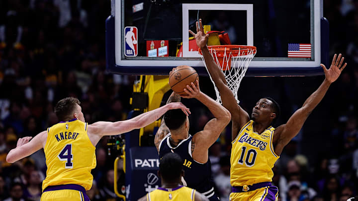 Mar 14, 2025; Denver, Colorado, USA; Denver Nuggets forward Michael Porter Jr. (1) attempts a shot under pressure from Los Angeles Lakers center Christian Koloko (10) and guard Dalton Knecht (4) in the fourth quarter at Ball Arena. Mandatory Credit: Isaiah J. Downing-Imagn Images
