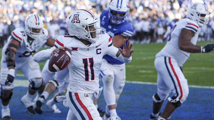 Oct 12, 2024; Provo, Utah, USA; Arizona Wildcats quarterback Noah Fifita (11) passes the ball from his own end zone against the Brigham Young Cougars during the fourth quarter at LaVell Edwards Stadium. 