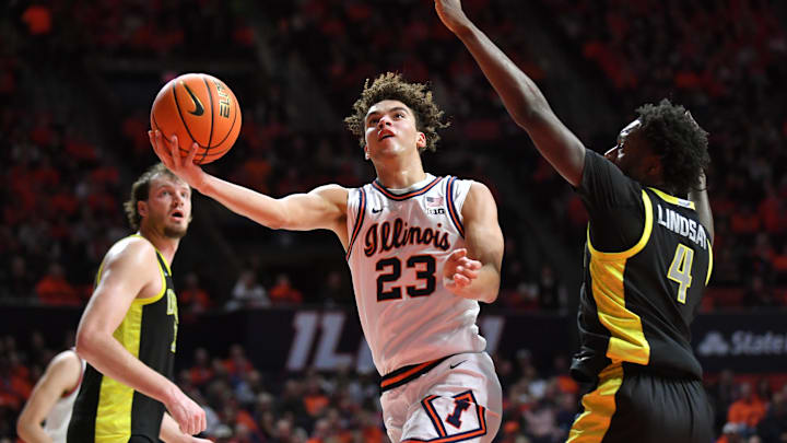 Mar 3, 2026; Champaign, Illinois, USA; Illinois Fighting Illini guard Keaton Wagler (23) drives past Oregon Ducks forward Dezdrick Lindsay (4) during the first half at State Farm Center. Mandatory Credit: Ron Johnson-Imagn Images