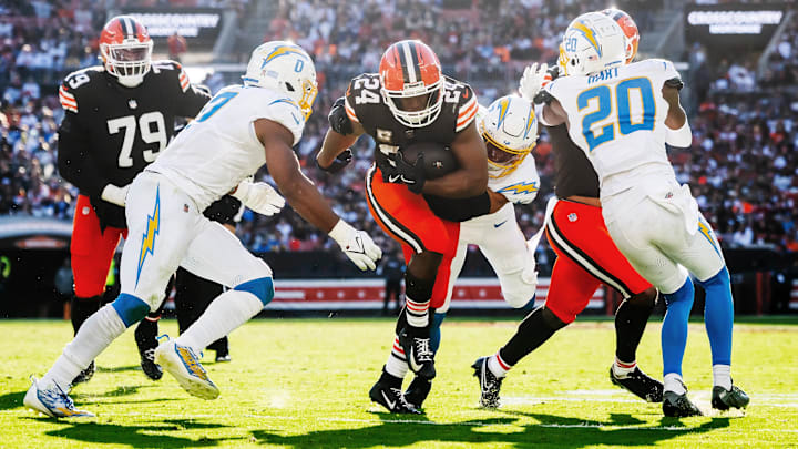 Nov 3, 2024; Cleveland, Ohio, USA; Cleveland Browns running back Nick Chubb (24) runs with the ball between Los Angeles Chargers linebacker Daiyan Henley (0) and cornerback Cam Hart (20) during the second half at Huntington Bank Field. Nov 3, 2024; Cleveland, Ohio, USA; Cleveland Browns running back Nick Chubb (24) runs with the ball between Los Angeles Chargers linebacker Daiyan Henley (0) and cornerback Cam Hart (20) during the second half at Huntington Bank Field.