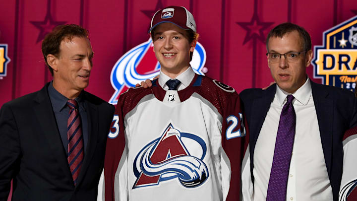 Jun 28, 2023; Nashville, Tennessee, USA; Colorado Avalanche draft pick Calum Ritchie stands with Ava staff after being selected with the twenty seventh pick in round one of the 2023 NHL Draft at Bridgestone Arena. Mandatory Credit: Christopher Hanewinckel-Imagn Images