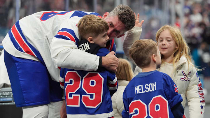 Feb 22, 2026; Milan, Italy; Brock Nelson (29) of the United States celebrates with his family after defeating Canada in the men's ice hockey gold medal game during the Milano Cortina 2026 Olympic Winter Games at Milano Santagiulia Ice Hockey Arena. Mandatory Credit: Amber Searls-Imagn Images