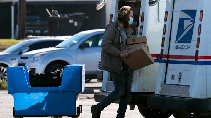 A rural carrier assistant loads packages into a mail truck at the United States Post Office in Henderson, Ky., Tuesday afternoon, Dec. 9, 2020.

1 USPS