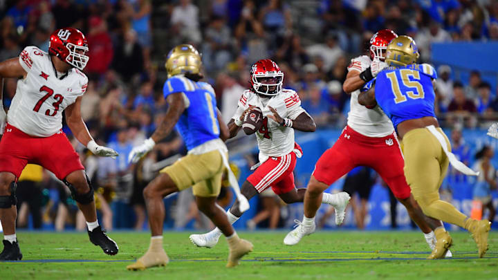 Utah Utes quarterback Devon Dampier (4) moves out to pass against the UCLA Bruins during the first half at Rose Bowl.