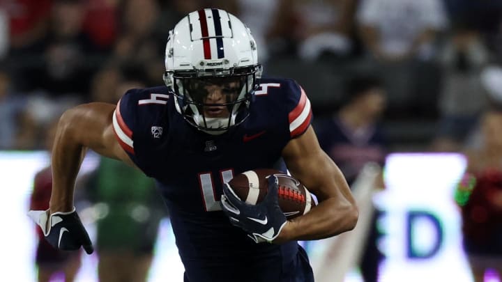 Nov 4, 2023; Tucson, Arizona, USA; Arizona Wildcats wide receiver Tetairoa McMillan (4) runs the ball during the second half at Arizona Stadium. Nov 4, 2023; Tucson, Arizona, USA; Arizona Wildcats wide receiver Tetairoa McMillan (4) runs the ball during the second half at Arizona Stadium.