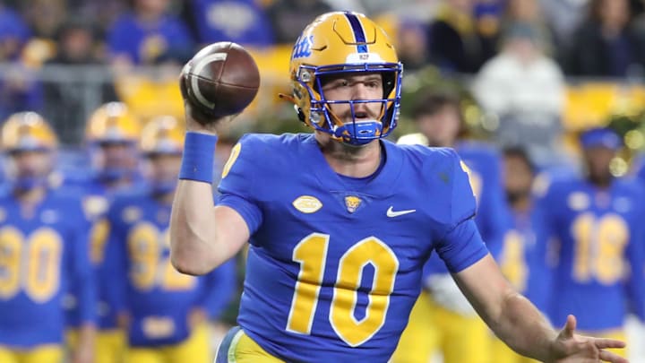 Nov 9, 2024; Pittsburgh, Pennsylvania, USA;  Pittsburgh Panthers quarterback Eli Holstein (10) scrambles with the ball against the Virginia Cavaliers during the second quarter at Acrisure Stadium. Mandatory Credit: Charles LeClaire-Imagn Images