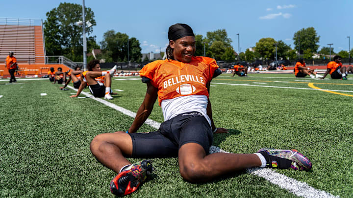 Senior Elijah Dotson, 17, stretches alongside his teammates during a team practice at the Belleville High School football field in Belleville on Wednesday, Aug. 14, 2024.