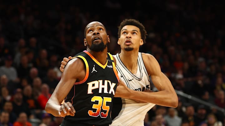 Dec 3, 2024; Phoenix, Arizona, USA; Phoenix Suns forward Kevin Durant (35) against San Antonio Spurs center Victor Wembanyama (1) in the first half of an NBA Cup game at Footprint Center. Mandatory Credit: Mark J. Rebilas-Imagn Images