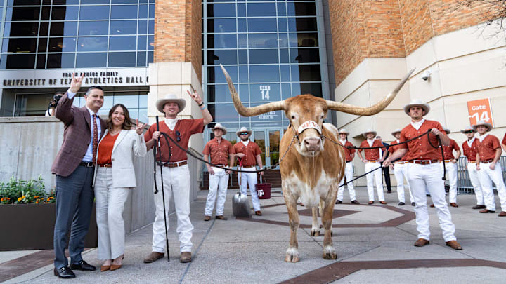Sean Miller and his wife, Amy Miller, pose with Bevo as The University of Texas announces Miller as their new men's basketball coach Tuesday, March 25, 2025. Sean Miller and his wife, Amy Miller, pose with Bevo as The University of Texas announces Miller as their new men's basketball coach Tuesday, March 25, 2025.
