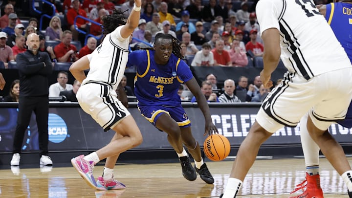 Mar 19, 2026; Oklahoma City, OK, USA; McNeese Cowboys guard Garwey Dual (3) drives to the hoop past Vanderbilt Commodores guard Chandler Bing (7) during the second half during a first round game of the men's 2026 NCAA Tournament at Paycom Center. Mandatory Credit: Alonzo Adams-Imagn Images