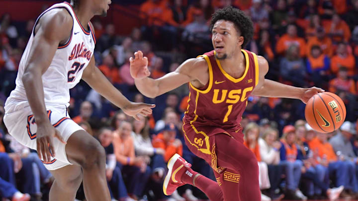 Jan 11, 2025; Champaign, Illinois, USA;  USC Trojans guard Desmond Claude (1) controls the ball as Illinois Fighting Illini forward Morez Johnson Jr. (21) defends during the second half at State Farm Center. Mandatory Credit: Ron Johnson-Imagn Images