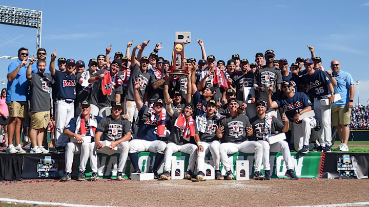 Jun 26, 2022; Omaha, NE, USA;  The Ole Miss Rebels celebrate with the championship trophy after the victory against the Oklahoma Sooners at Charles Schwab Field. Mandatory Credit: Steven Branscombe-Imagn Images