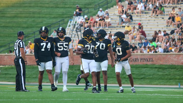 Aug 17, 2024; Columbia, Missouri USA; Missouri Tigers running back Jamal Roberts (20, center) walks with the offensive line during the team's practice at Faurot Field.