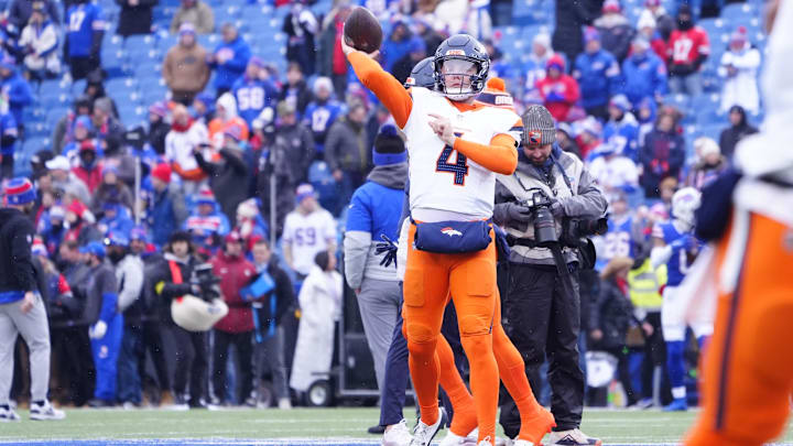 Denver Broncos quarterback Zach Wilson (4) warms up before a game against the Buffalo Bills in an AFC wild card game at Highmark Stadium.