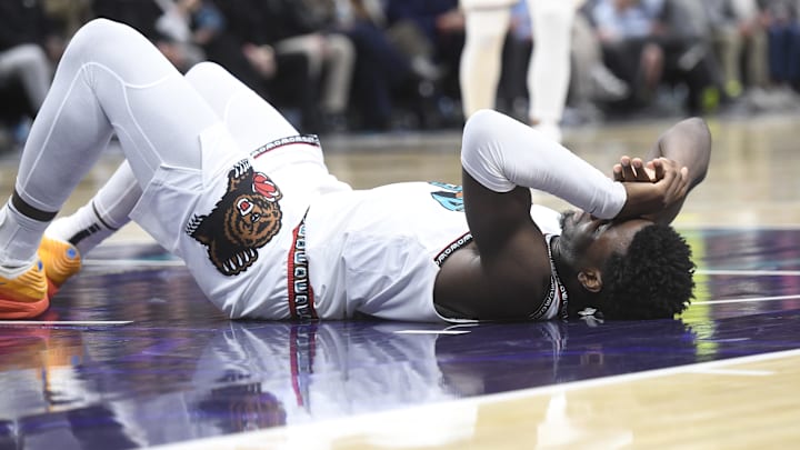 Apr 8, 2025; Charlotte, North Carolina, USA;  Memphis Grizzlies center Jaren Jackson Jr. (13) lays on the floor briefly after falling hard during the second half against the Charlotte Hornets at the Spectrum Center. Mandatory Credit: Sam Sharpe-Imagn Images