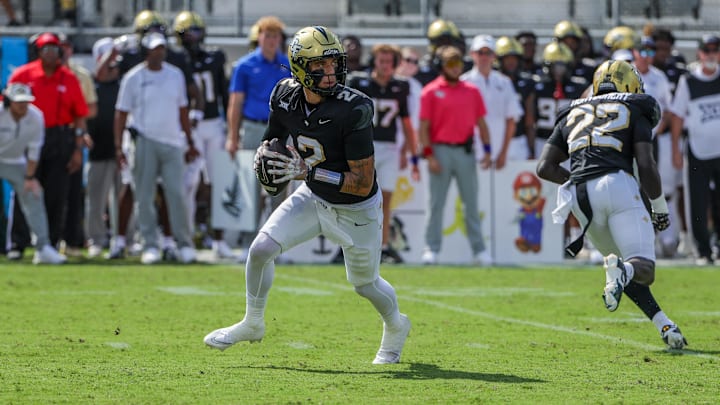 Sep 20, 2025; Orlando, Florida, USA; UCF Knights quarterback Tayven Jackson (2) rolls back to pass during the first quarter against the North Carolina Tar Heels at the Bounce House Stadium. Mandatory Credit: Mike Watters-Imagn Images