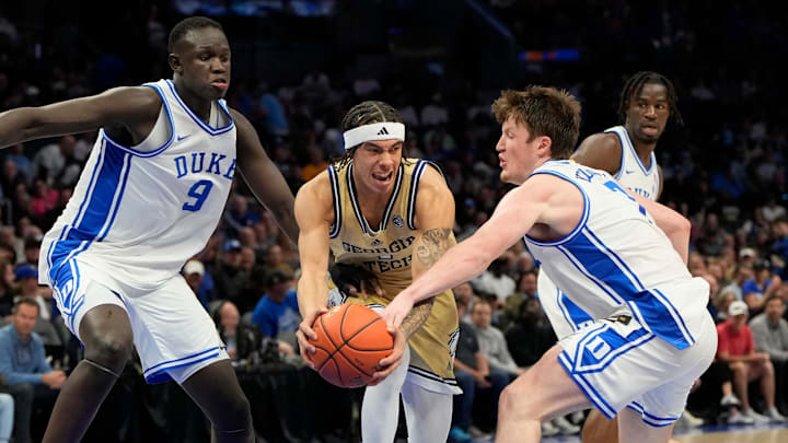 Mar 13, 2025; Charlotte, NC, USA; Georgia Tech Yellow Jackets guard Naithan George (1) with the ball as Duke Blue Devils center Khaman Maluach (9) and Duke Blue Devils guard Kon Knueppel (7) defend in the seocnd half at Spectrum Center. Mandatory Credit: Bob Donnan-Imagn Images Mar 13, 2025; Charlotte, NC, USA; Georgia Tech Yellow Jackets guard Naithan George (1) with the ball as Duke Blue Devils center Khaman Maluach (9) and Duke Blue Devils guard Kon Knueppel (7) defend in the seocnd half at Spectrum Center. Mandatory Credit: Bob Donnan-Imagn Images