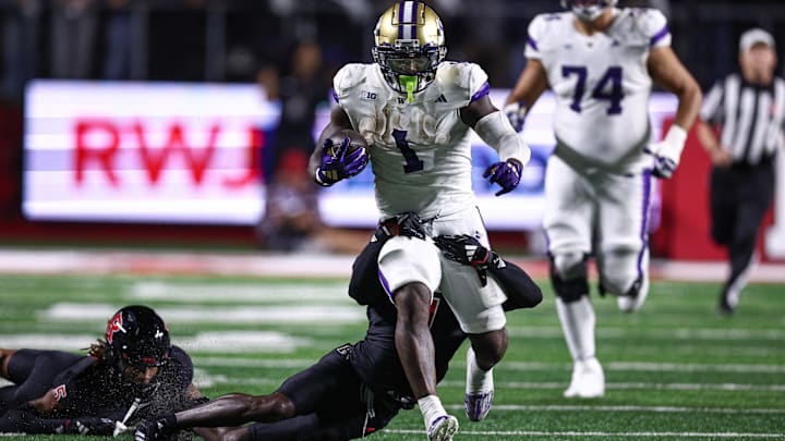 Huskies running back Jonah Coleman (1) gets tackled by Rutgers defensive back Robert Longerbeam in their 2024 game. Huskies running back Jonah Coleman (1) gets tackled by Rutgers defensive back Robert Longerbeam in their 2024 game.