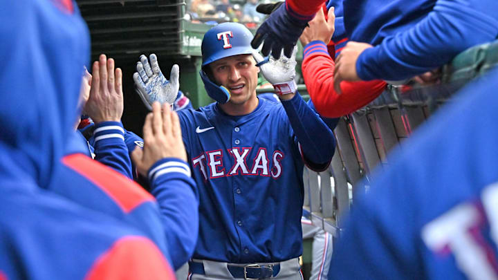 Apr 9, 2025; Chicago, Illinois, USA; Texas Rangers shortstop Corey Seager (5) celebrates with teammates in the dugout after hitting a home run during the seventh inning against the Chicago Cubs at Wrigley Field. 