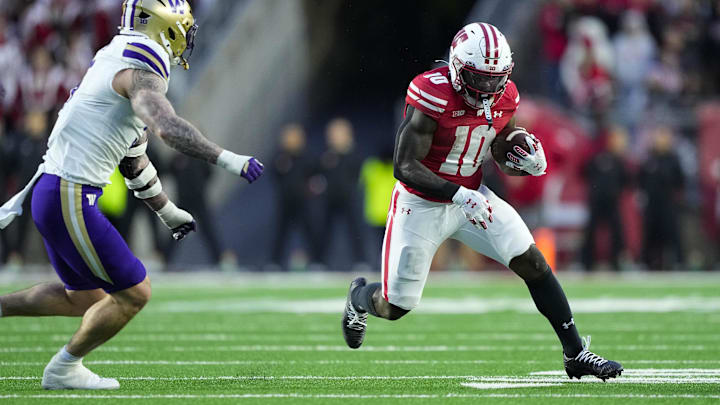 Nov 8, 2025; Madison, Wisconsin, USA;  Wisconsin Badgers running back Gideon Ituka (10) rushes with the football during the first quarter against the Washington Huskies at Camp Randall Stadium. Mandatory Credit: Jeff Hanisch-Imagn Images