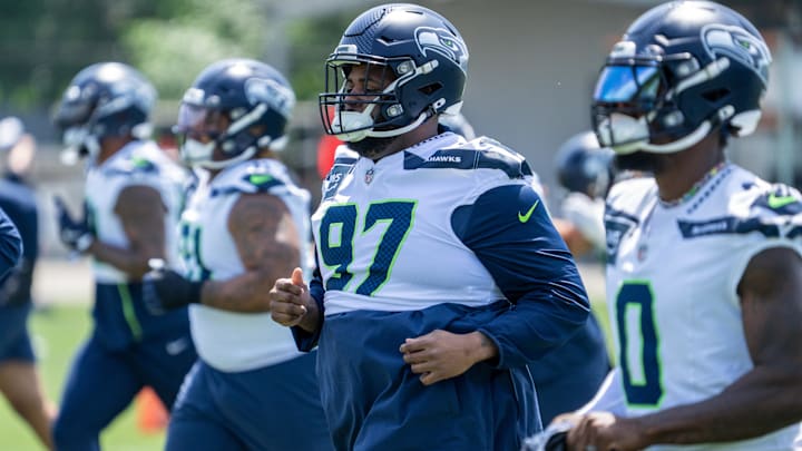 Seattle Seahawks defensive lineman Johnathan Hankins and DeMarcus Lawrence take part in drills during mini-camp.