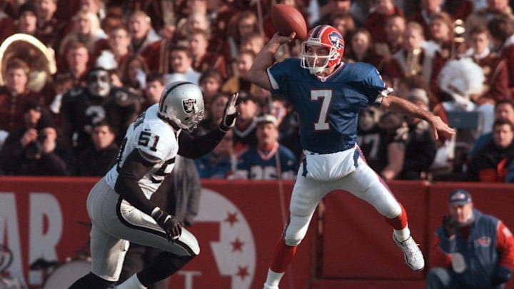 In true Flutie form, Doug Flutie leaps high to get a pass over Raiders LB Lance Johnstone.