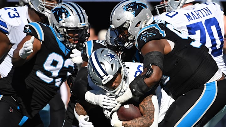 Nov 19, 2023; Charlotte, North Carolina, USA; Dallas Cowboys running back Rico Dowdle (23) is tackled by Carolina Panthers defensive tackles LaBryan Ray (93) and Derrick Brown (95) in the second quarter at Bank of America Stadium. Nov 19, 2023; Charlotte, North Carolina, USA; Dallas Cowboys running back Rico Dowdle (23) is tackled by Carolina Panthers defensive tackles LaBryan Ray (93) and Derrick Brown (95) in the second quarter at Bank of America Stadium.