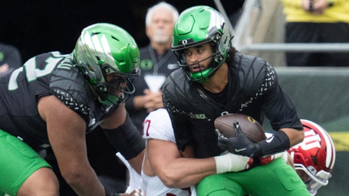 Oregon quarterback Dante Moore, right, is sacked on the opening drive of the game against Indiana at Autzen Stadium October 11, 2025.