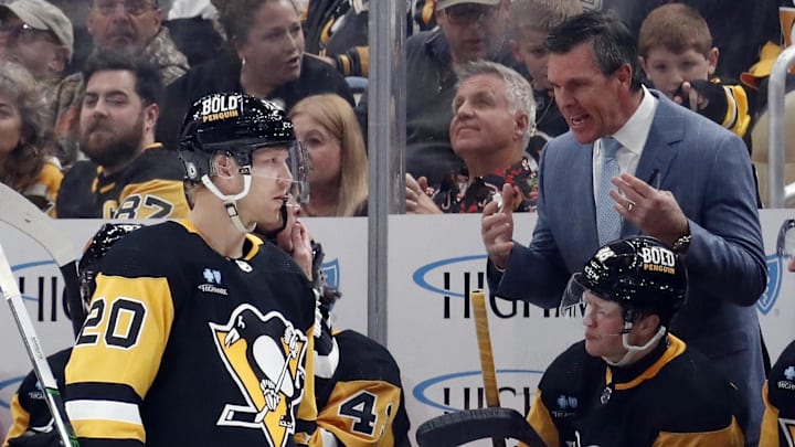 Dec 18, 2023; Pittsburgh, Pennsylvania, USA;  Pittsburgh Penguins head coach Mike Sullivan (right) talks with center Lars Eller (20) at the bench against the Minnesota Wild during the third period at PPG Paints Arena. Pittsburgh won 4-3. Mandatory Credit: Charles LeClaire-Imagn Images