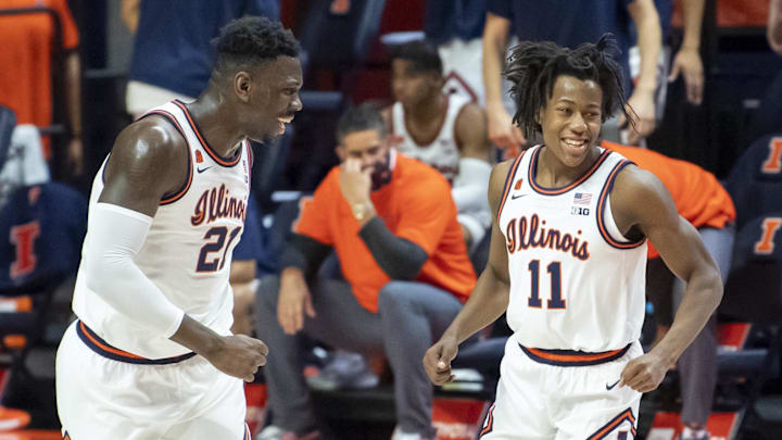 Jan 2, 2021; Champaign, Illinois, USA; Illinois Fighting Illini center Kofi Cockburn (21) and guard Ayo Dosunmu (11) celebrate during the first half against the Purdue Boilermakers at the State Farm Center. Mandatory Credit: Patrick Gorski-Imagn Images