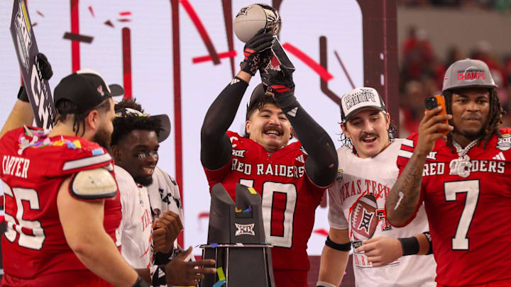 Jacob Rodriguez lifts the trophy after Texas Tech defeated BYU in the Big 12 Conference championship game, Saturday, Nov. 6, 2025, at AT&T Stadium in Arlington.