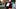Two boys (6-7) wearing Halloween costume leaning on fence Two boys (6-7) wearing Halloween costume leaning on fence