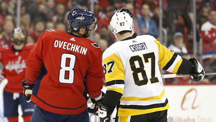 Nov 7, 2018; Washington, DC, USA; Pittsburgh Penguins center Sidney Crosby (87) and Washington Capitals left wing Alex Ovechkin (8) talk with referee Wes McCauley (4) in the third period at Capital One Arena. Mandatory Credit: Geoff Burke-Imagn Images